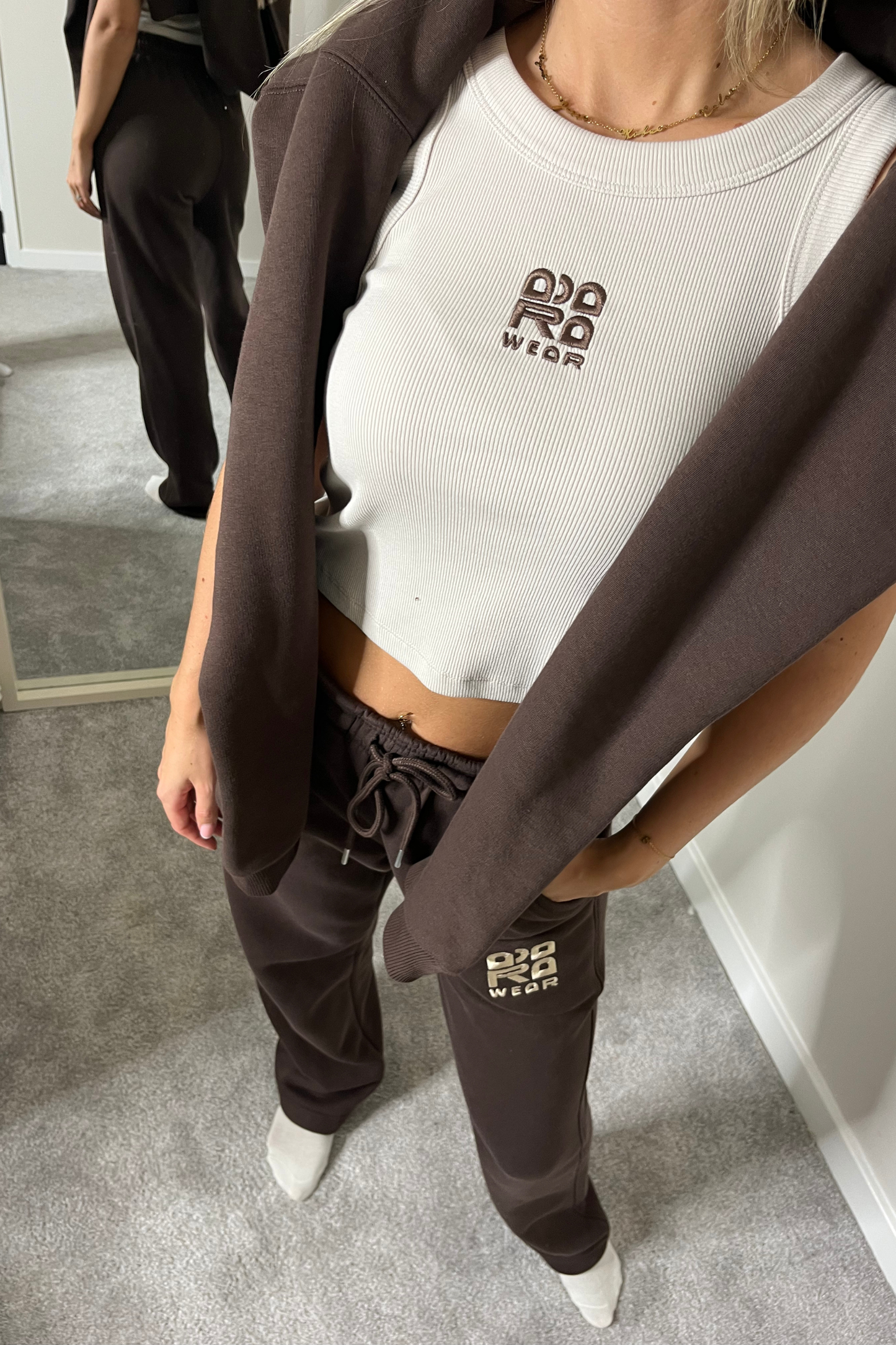 Beige cropped racer neck top with brown embroidery