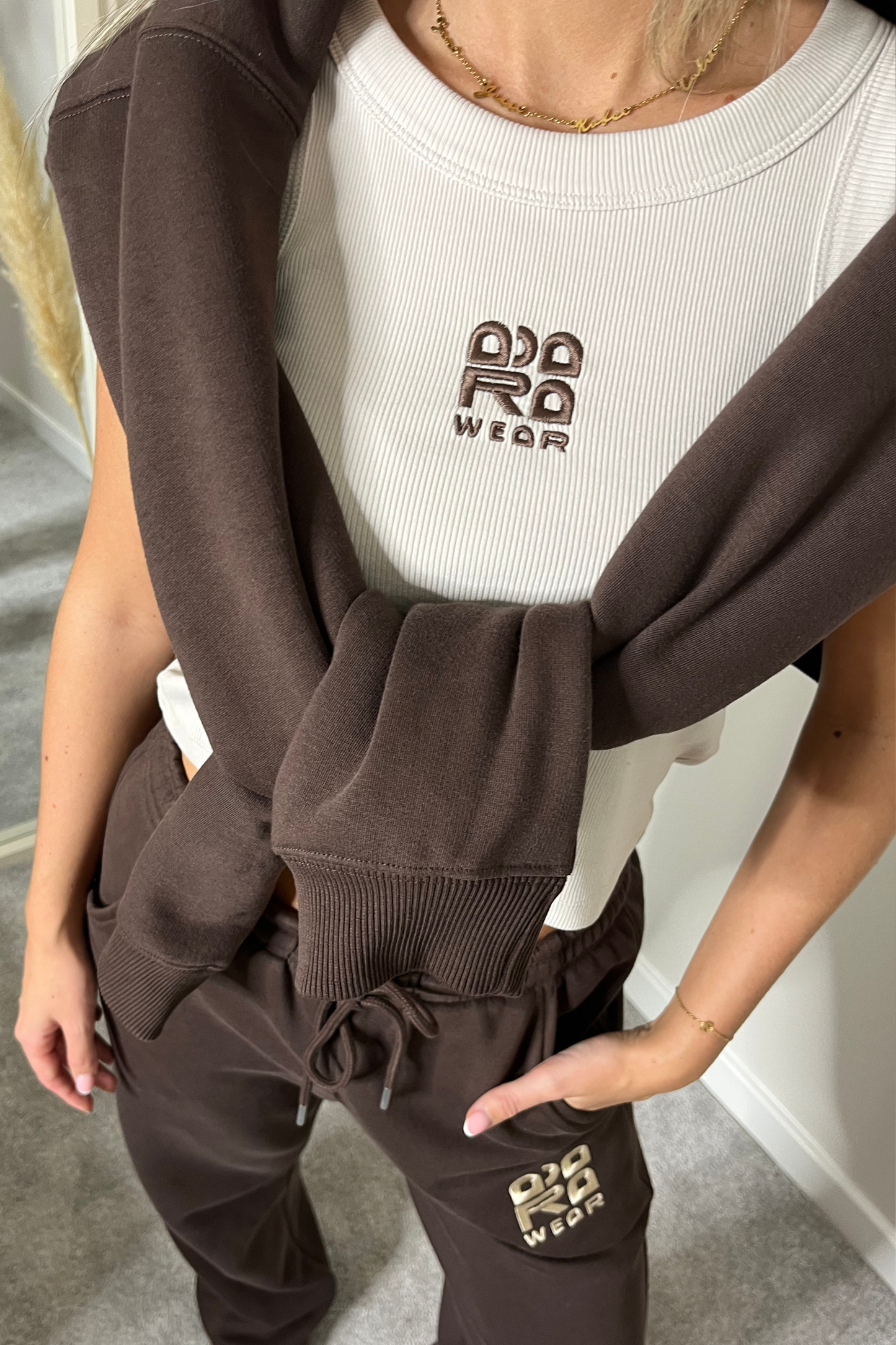 Beige cropped racer neck top with brown embroidery